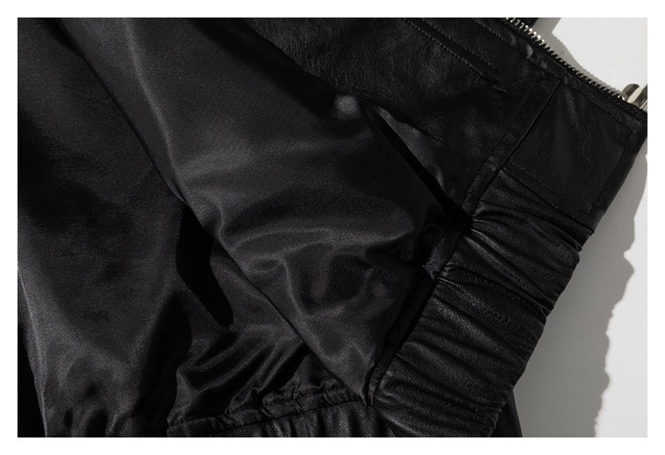 Close-up of the black garment's smooth inner lining, gathered elastic edge, and metal zipper.