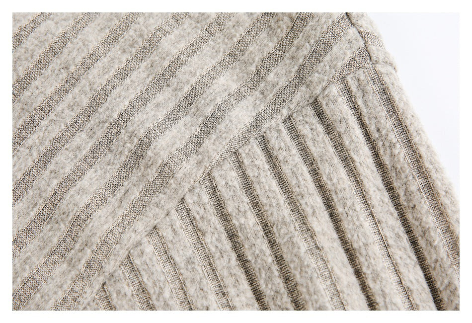 Close-up of gray striped fabric showing a shoulder seam and the garment's textured pattern.