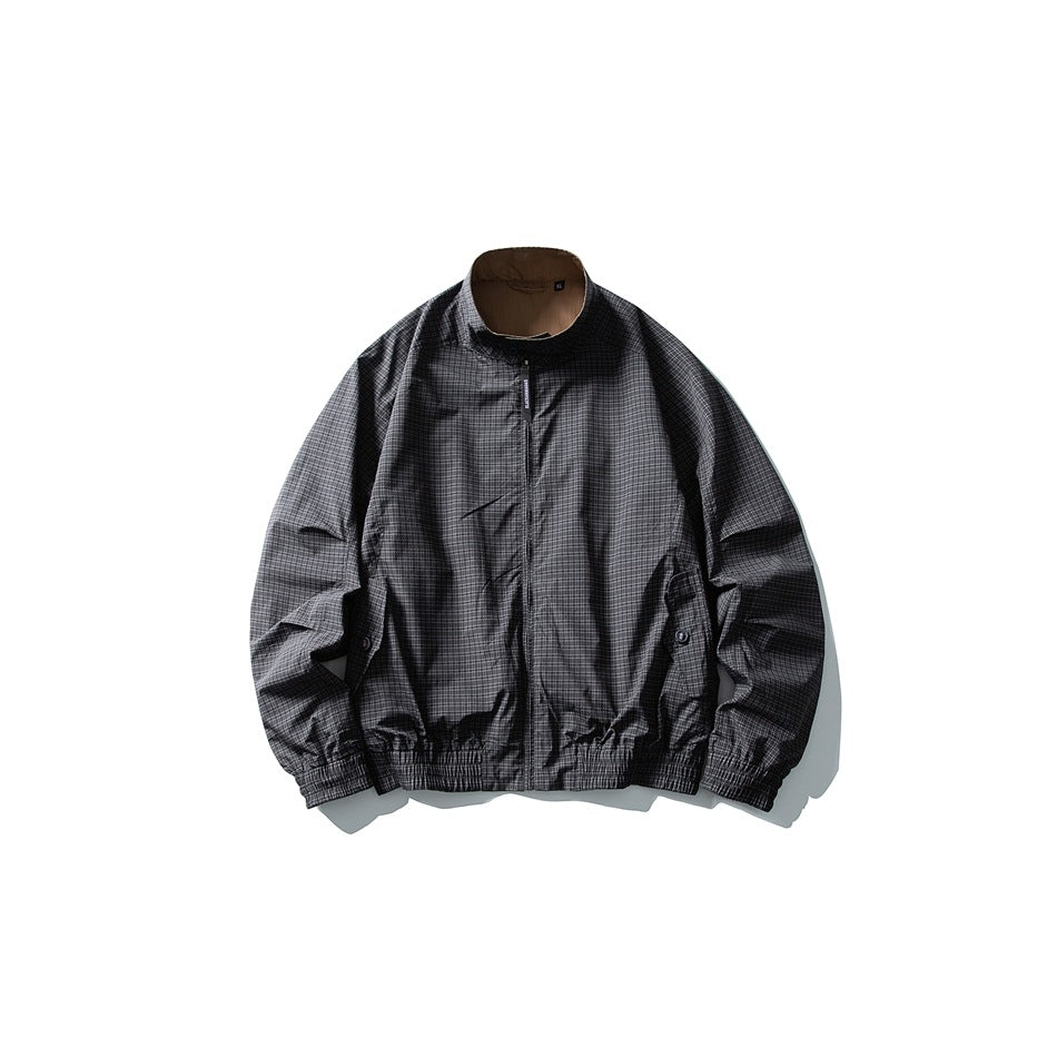 Charcoal black fine-check zip jacket flat lay with stand collar and tan reverse visible at collar