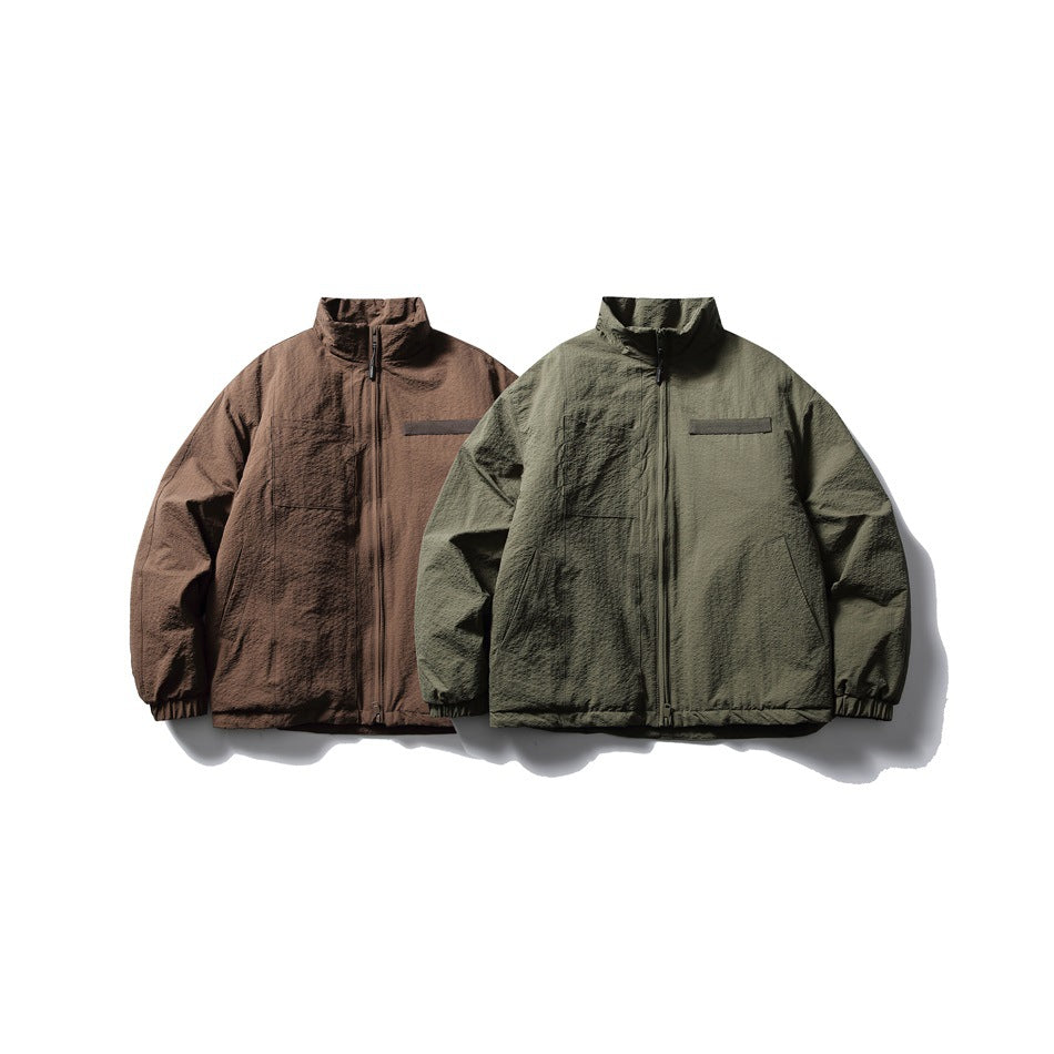 Two zip-front jackets shown side by side in brown and olive green, with high collars and elastic cuffs.