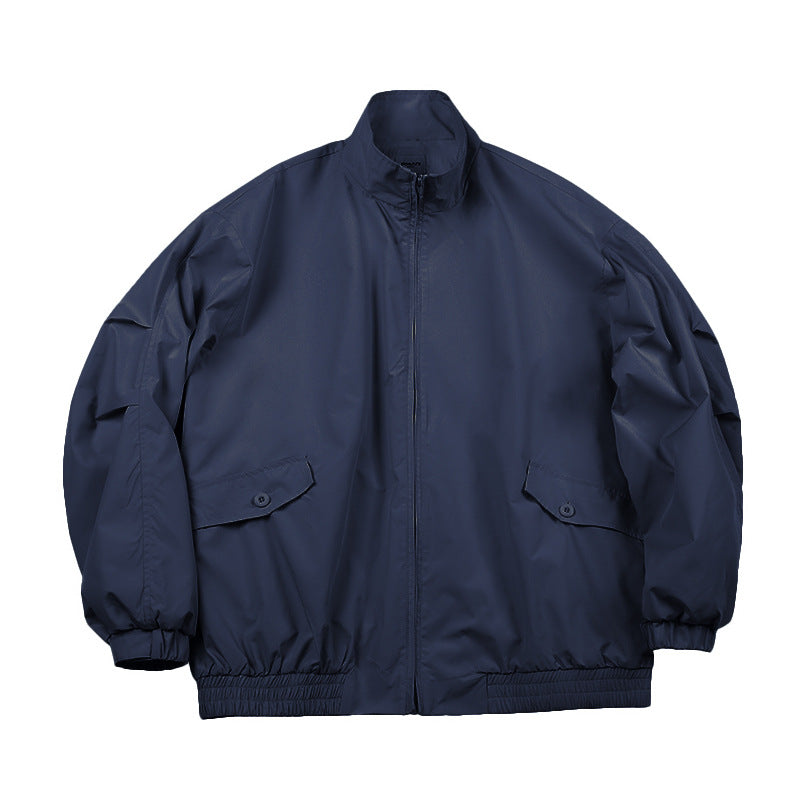 Navy blue stand-collar zip jacket with flap pockets and elastic cuffs, flat lay front view