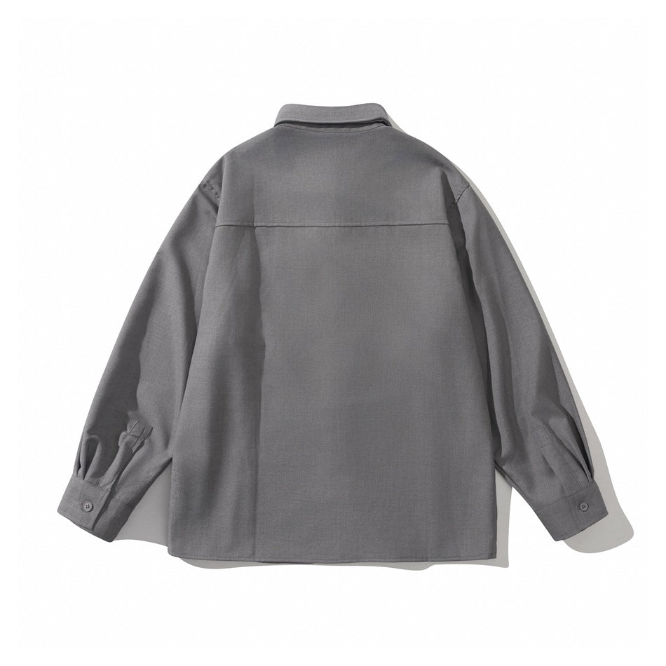 Back view of a gray long-sleeved button-up shirt with a horizontal yoke seam and button cuffs.