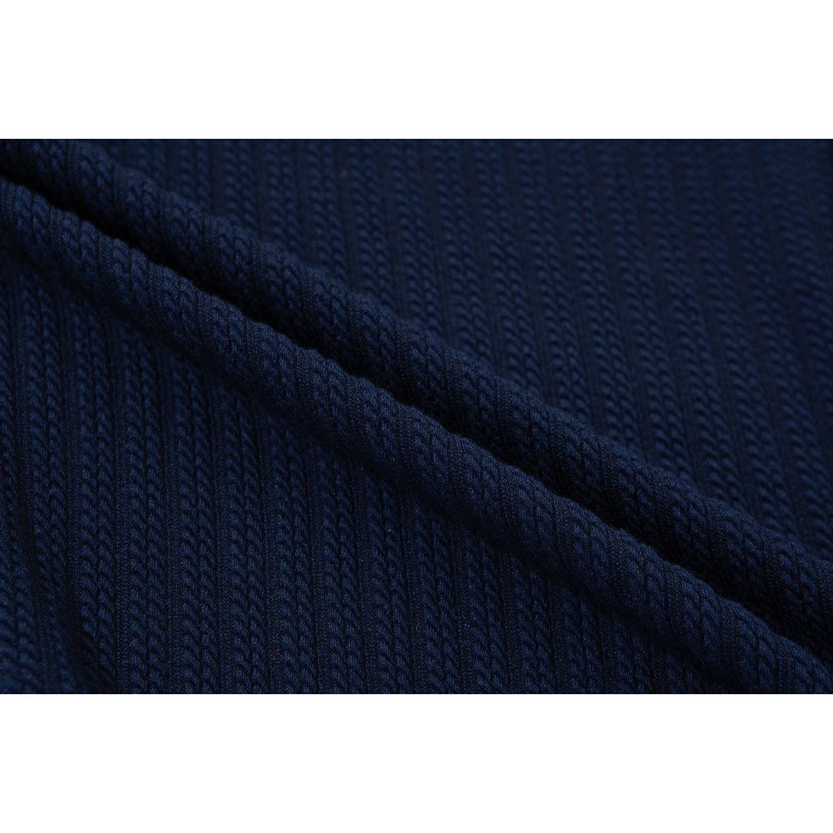 Macro view of the navy top's raised ribbed knit texture.