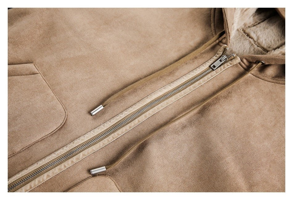 Close-up of a tan jacket with a diagonal metal zipper, drawstrings, a pocket, and pale faux-fur lining at the collar.