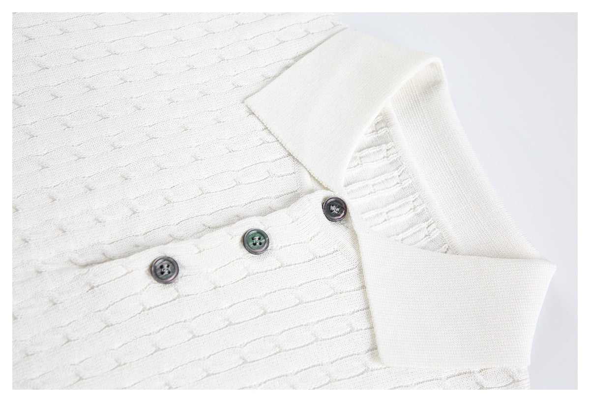Close-up of an ivory knit polo collar and placket with three dark buttons and textured stitching.
