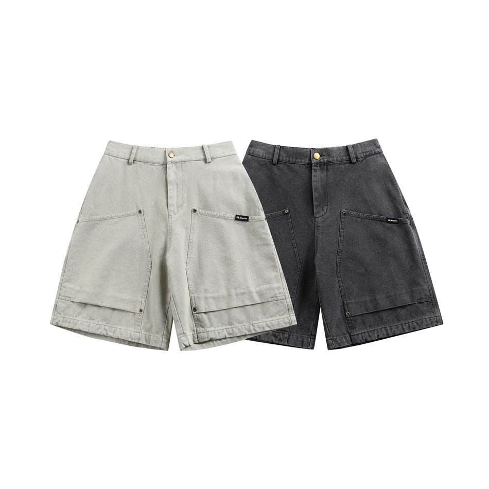 Two pairs of utility shorts displayed from the front in light gray and charcoal, with large patch pockets.