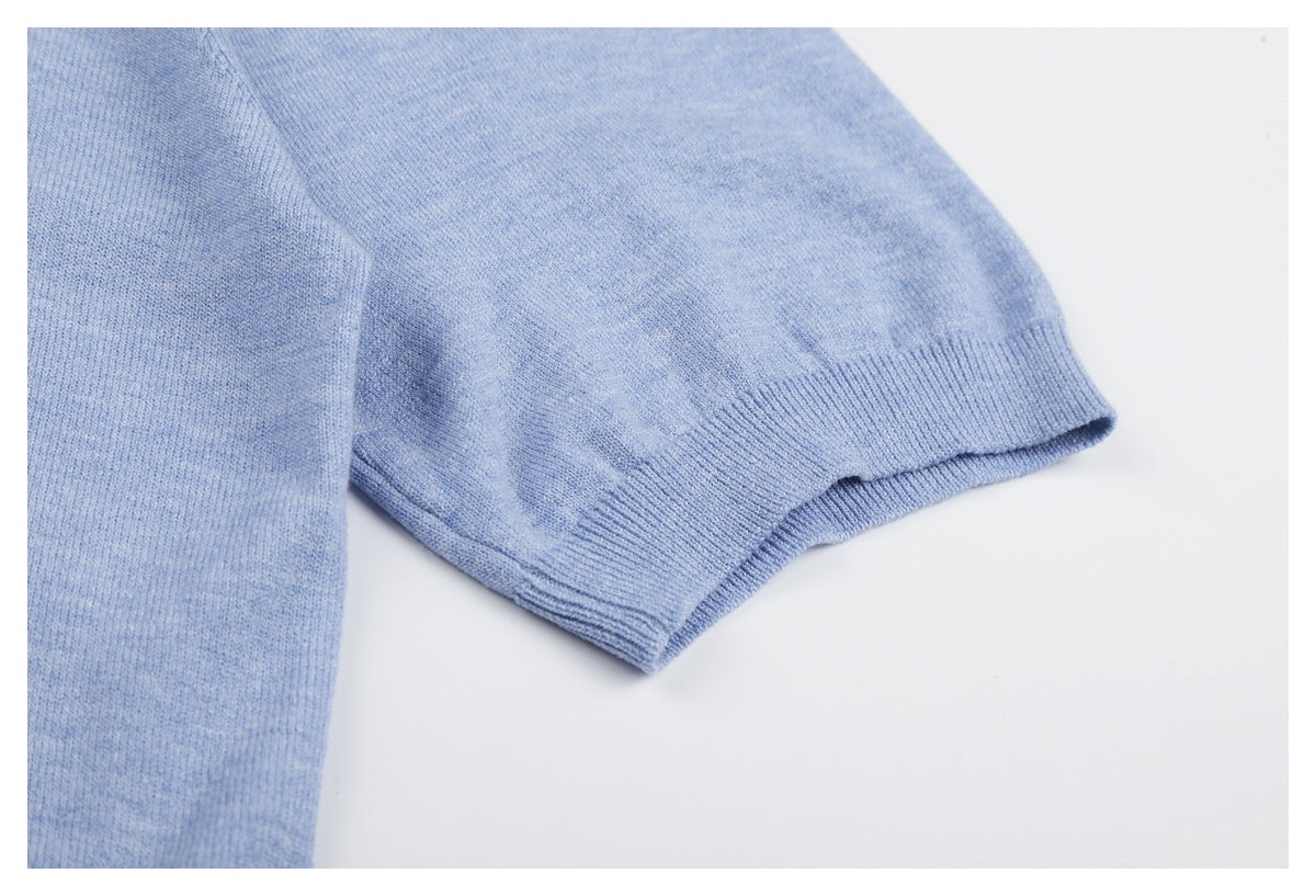 Close-up of a light blue knit sleeve ending in a ribbed cuff.