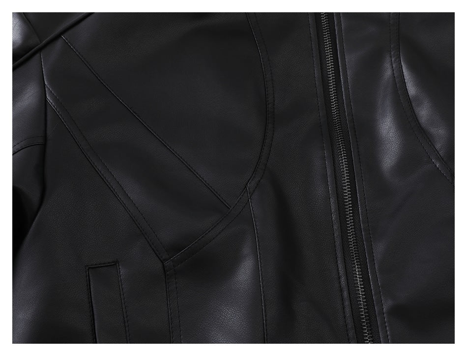 Close-up of the black jacket's front panel seams, pocket opening, and zipper.