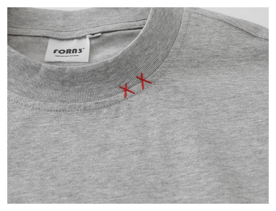 Close-up of a heather-gray T-shirt crew neck, red X-shaped stitches, and sewn-in brand label.