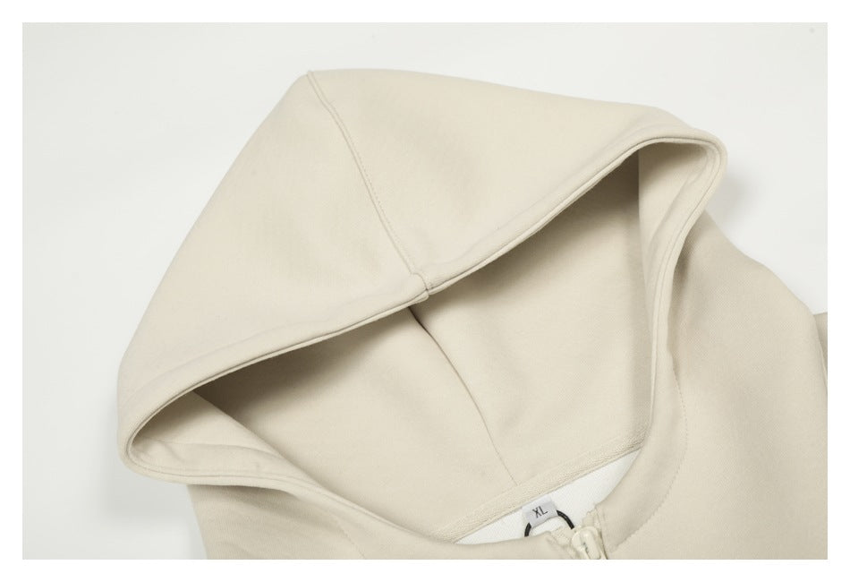 Close-up of the cream hoodie’s hood and inner seam, with an XL neck tag visible.