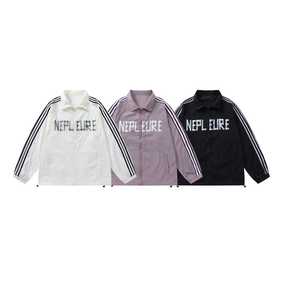 Three zip jackets shown from the front in white, mauve, and black, with striped sleeves and large chest lettering.