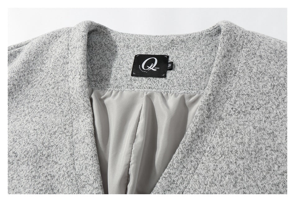 Close-up of the garment's gray marled neckline, pale lining, and black Q Mode label.