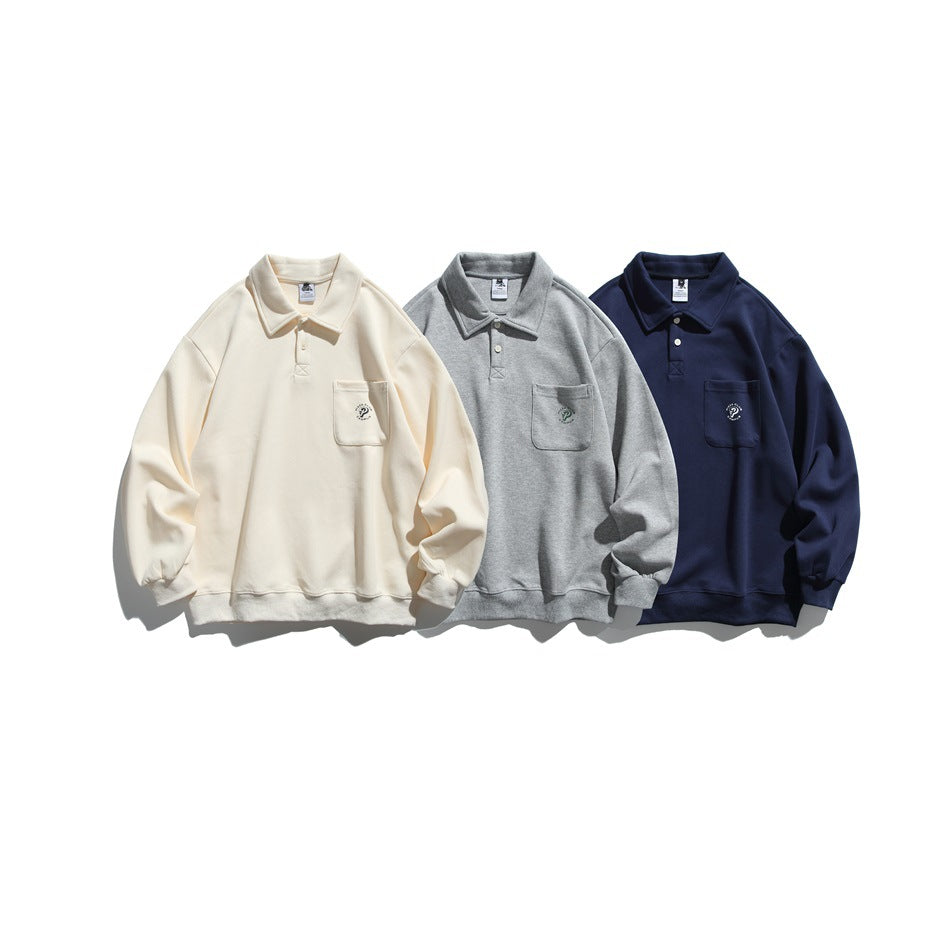 Three collared pullovers with chest pockets shown together in cream, heather gray, and navy.
