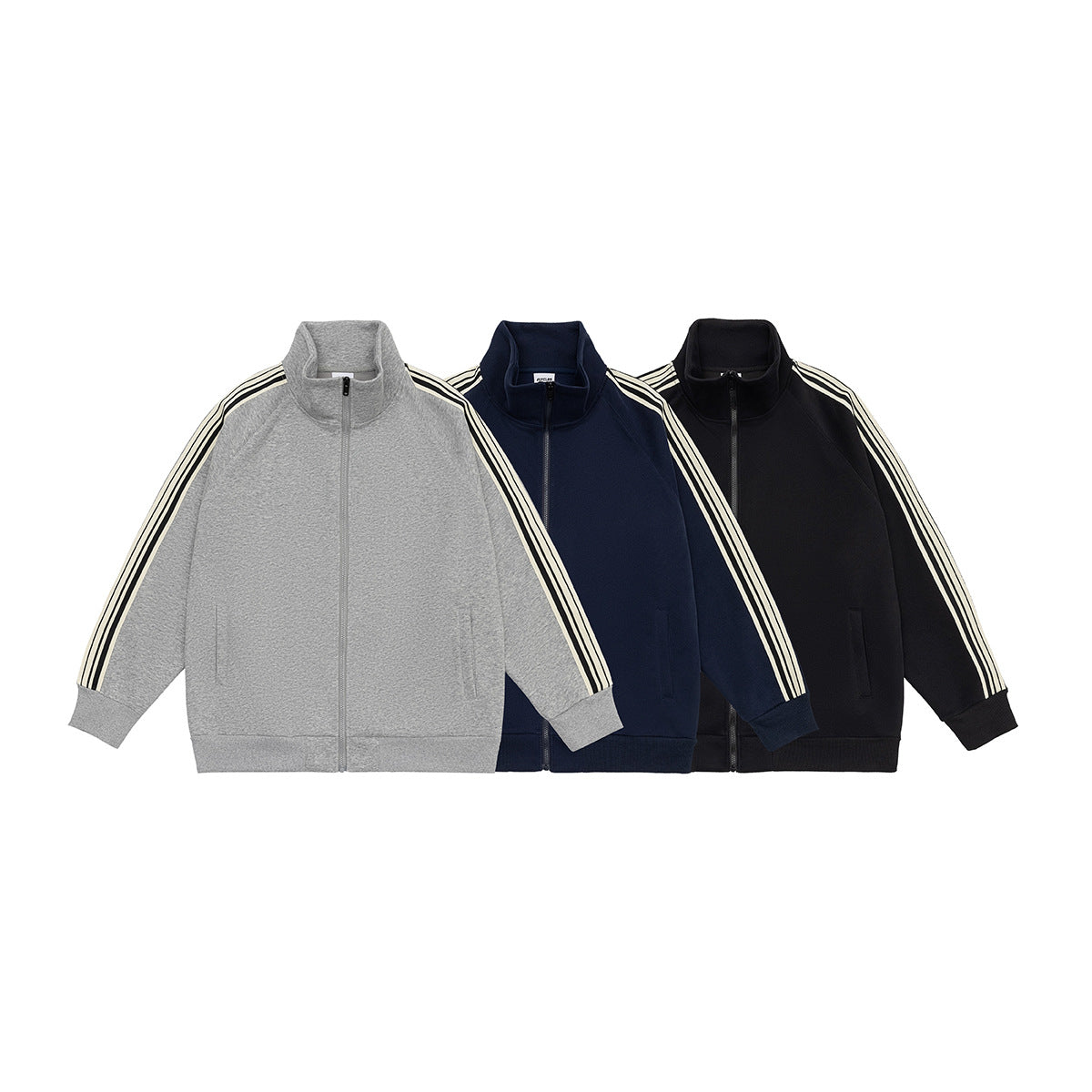 Three front views of the same zip-up track jacket in gray, navy, and black, each with striped sleeves.