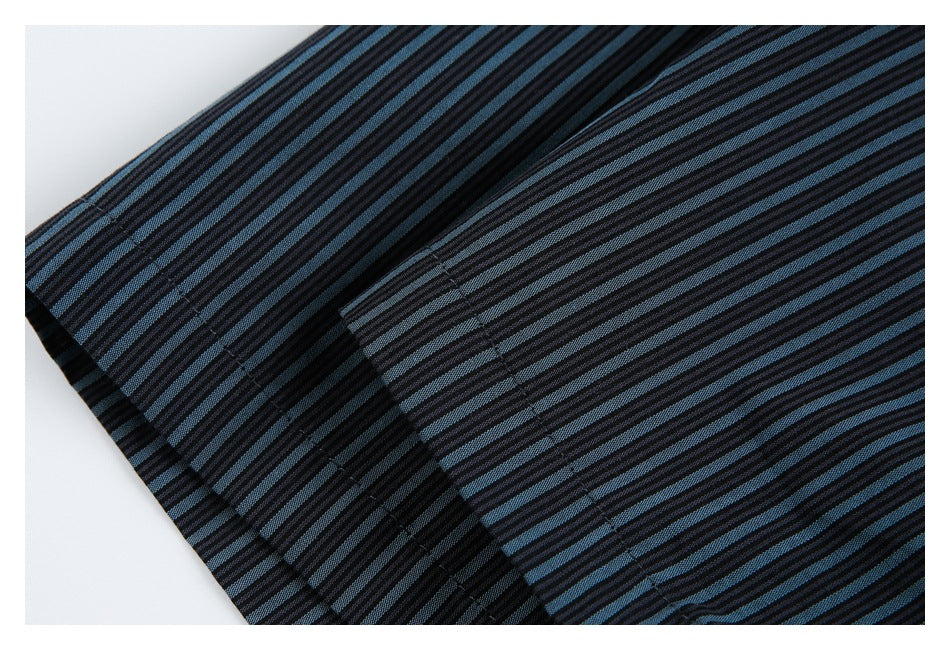 Close-up of the black and blue striped shirt fabric and stitched edge.