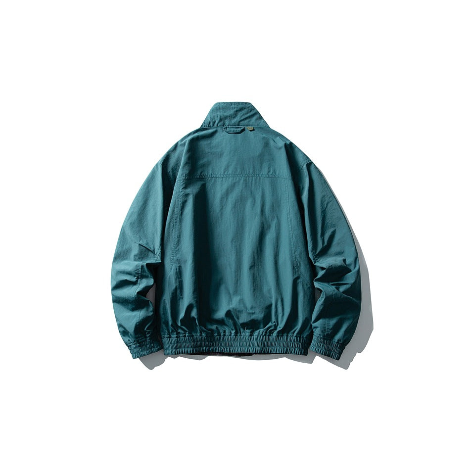 Teal collared jacket shown from the back, with long sleeves and elastic cuffs and hem.