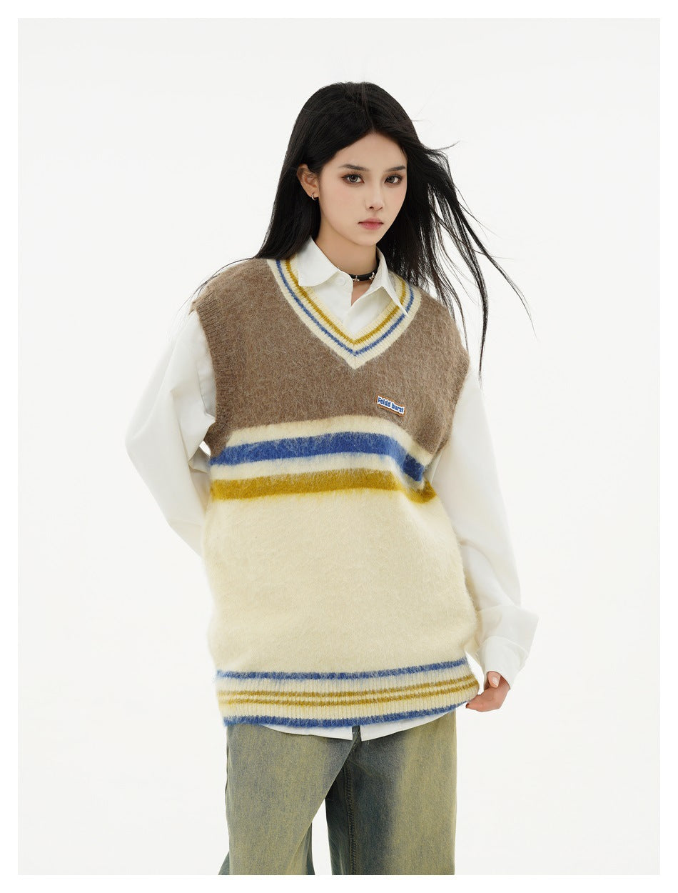 Front view of a model wearing a brown and cream striped V-neck sweater vest over a white shirt.