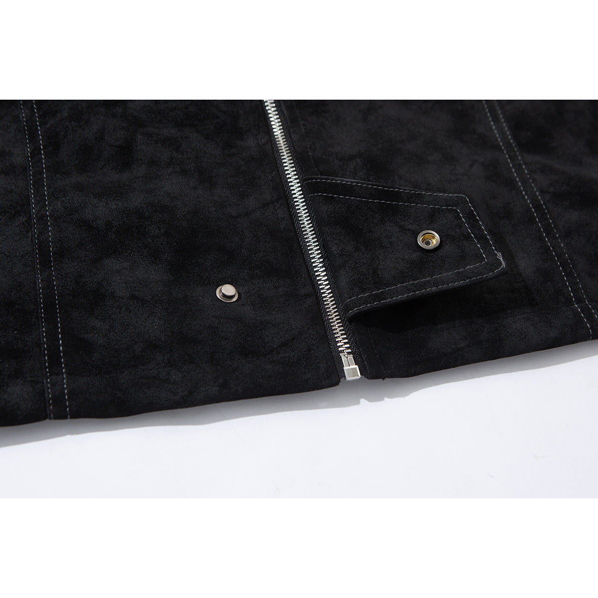 Close-up of the black jacket's front zipper and snap-button flap pocket.
