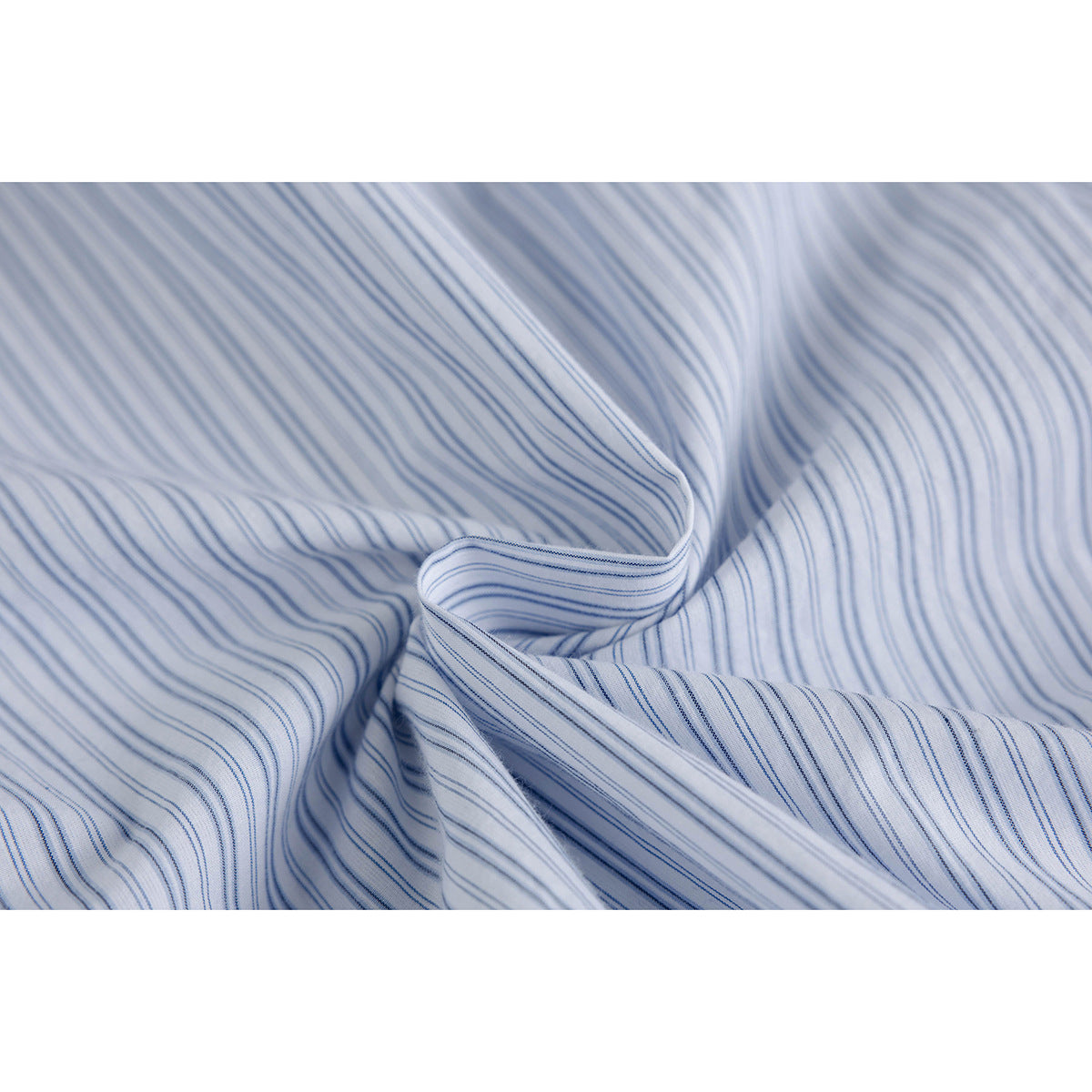 Close-up of white fabric with fine blue stripes, gathered into soft folds.