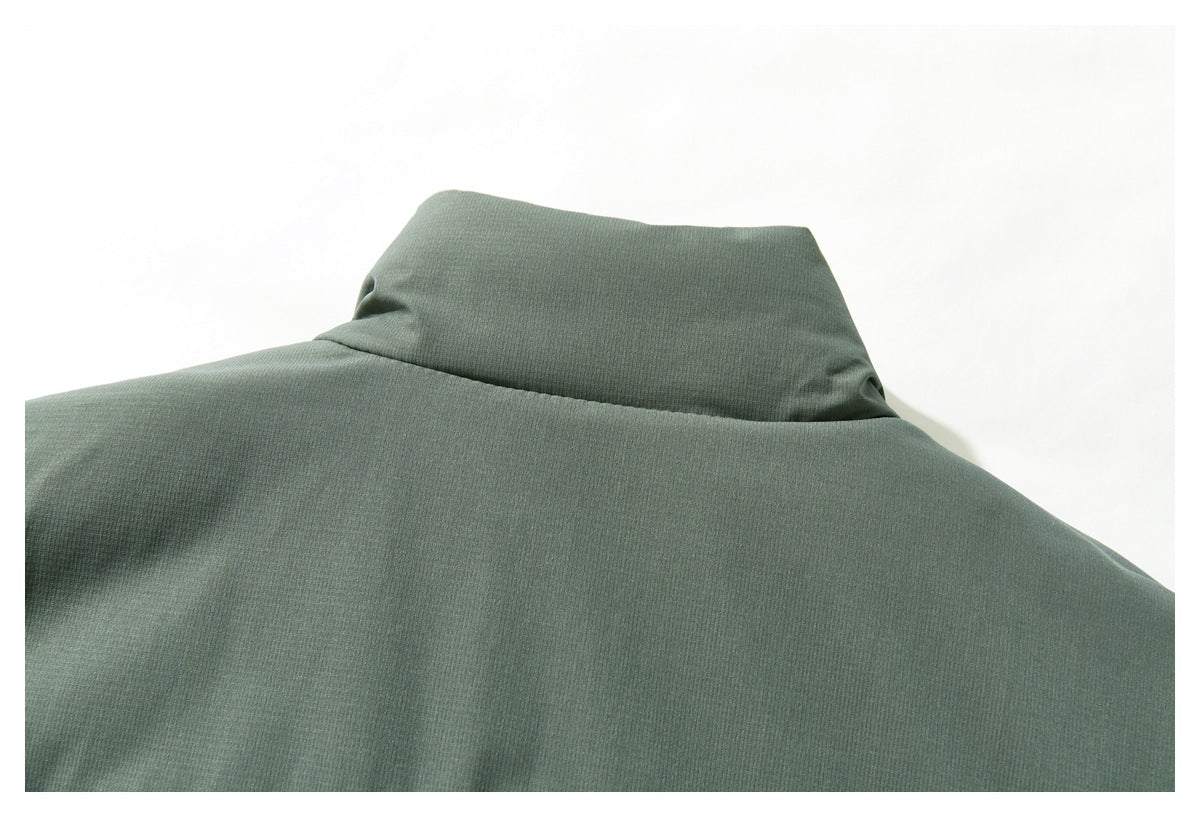 Close-up of the sage-green jacket's back collar and smooth upper-back fabric.
