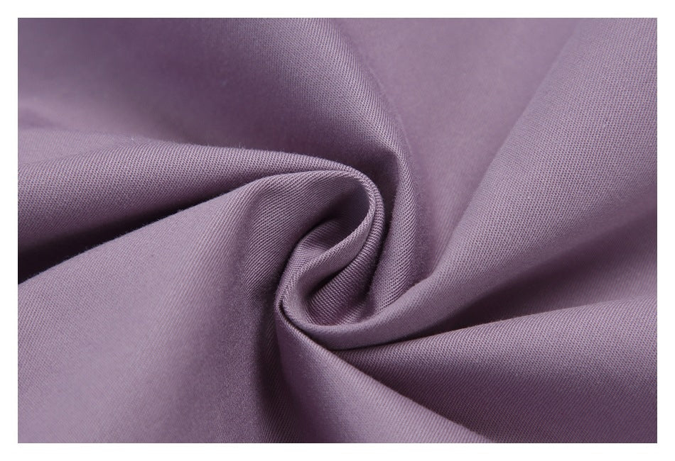 Close-up of muted lavender fabric gathered into a spiral fold.
