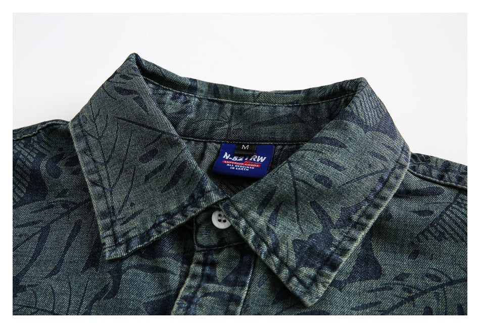 Close-up of the shirt's pointed collar, top button, leaf print, and sewn-in neck label.