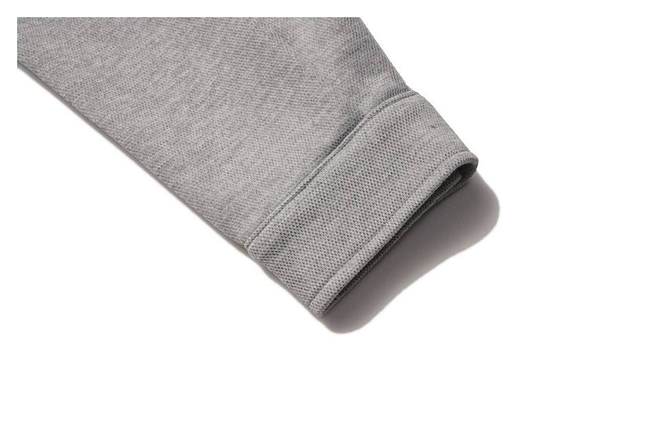 Close-up of a gray sweatshirt sleeve ending in a wide folded cuff.