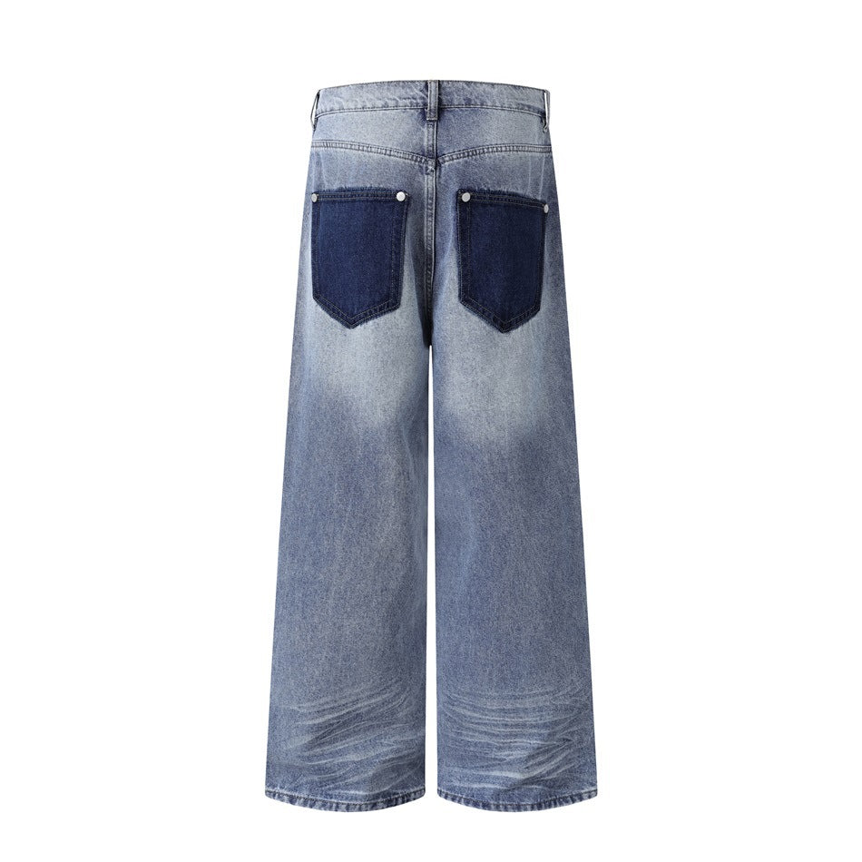 Back view of wide-leg blue jeans with two dark contrast patch pockets and faded whiskering near the hems.