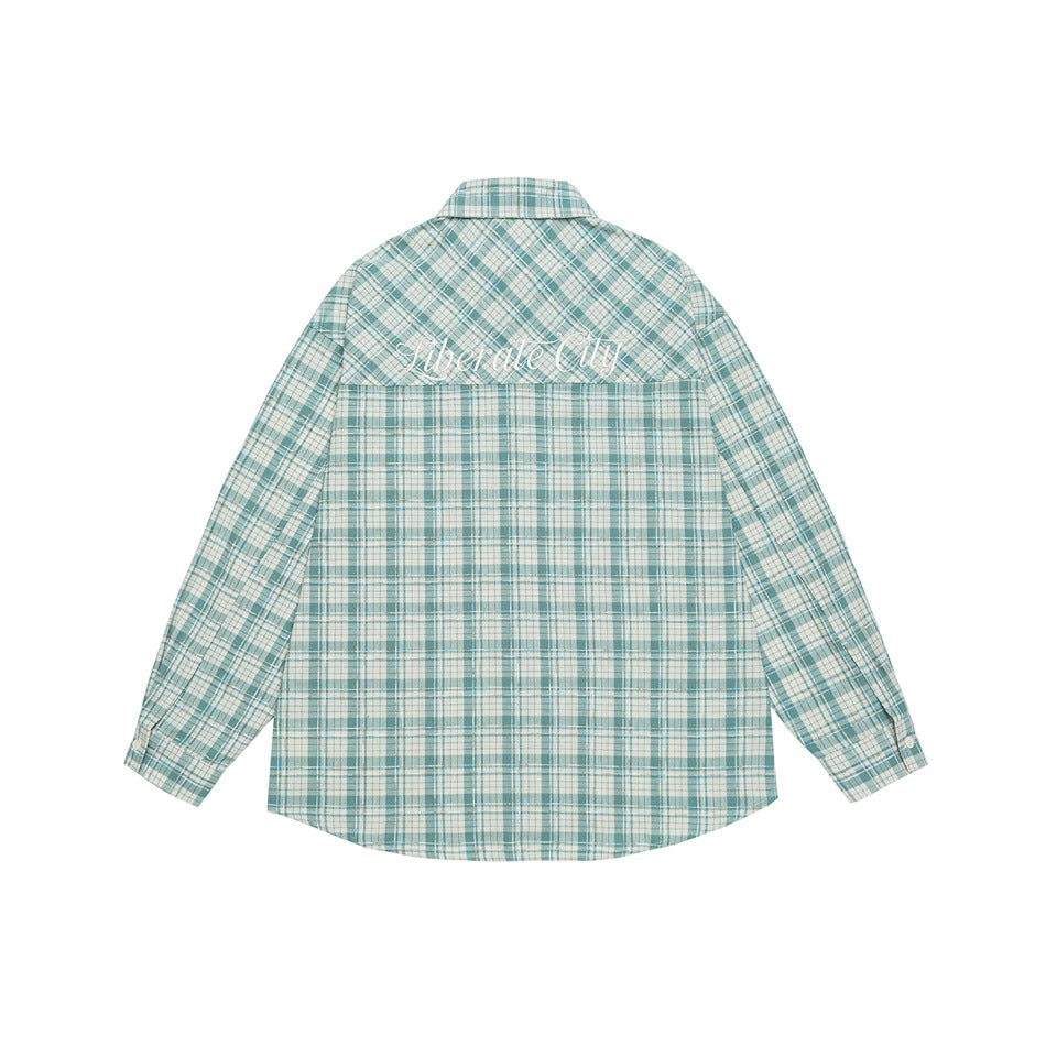 Back of a teal-and-white plaid long-sleeve shirt with white script embroidery across the upper back.
