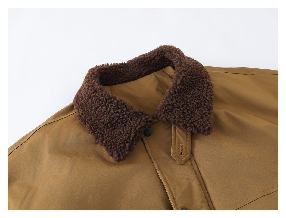Close-up of the jacket's dark brown textured collar, tan fabric, and front snap-button placket.