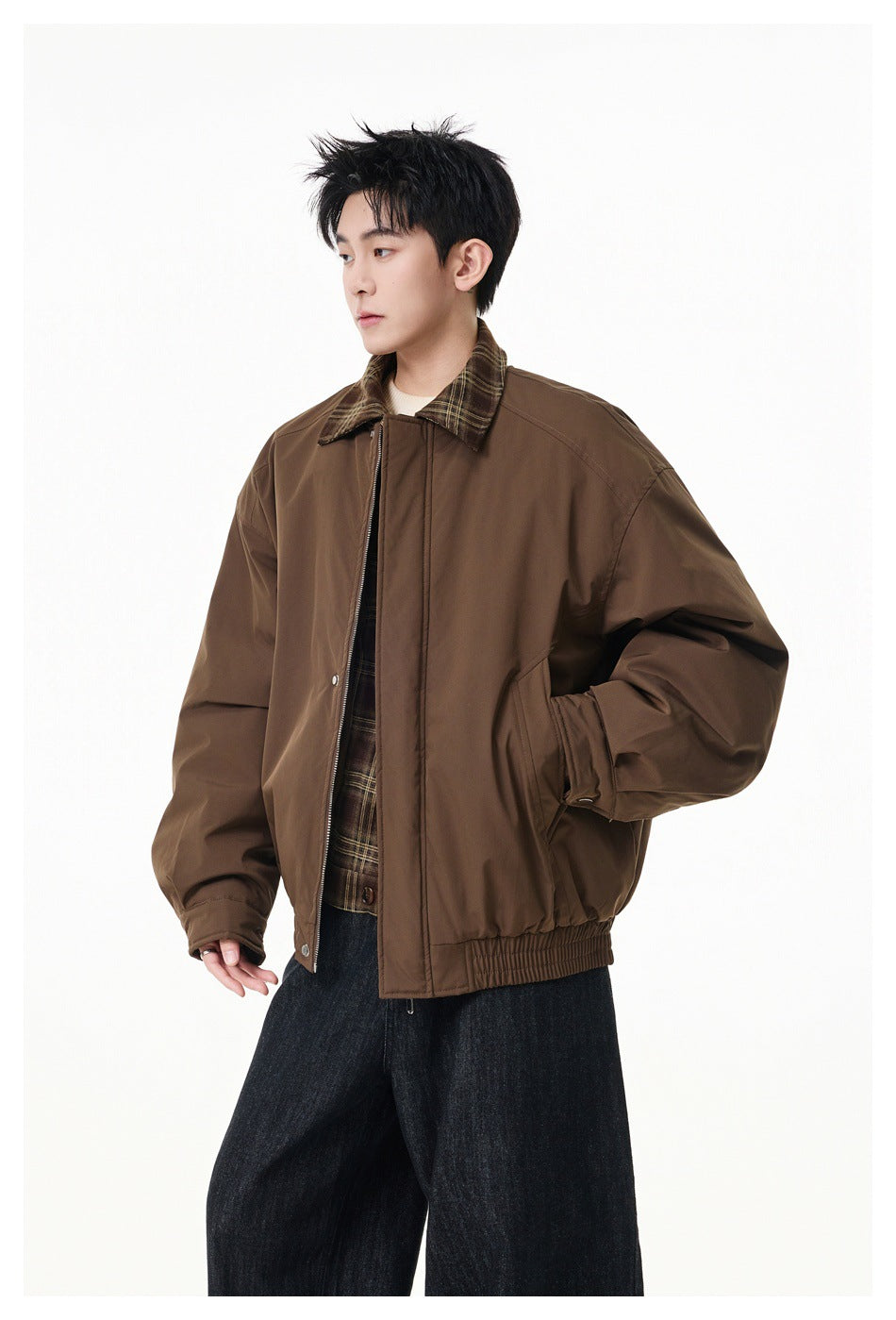 Model wearing a brown zip jacket with plaid collar, elastic hem and snap cuffs, with dark wide-leg jeans