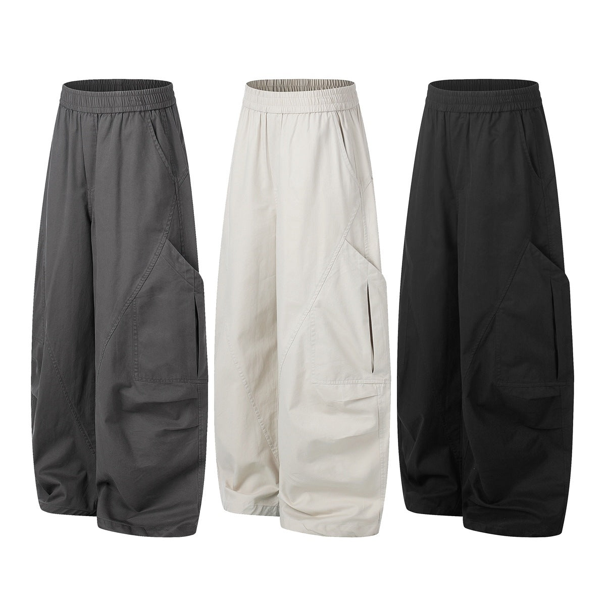 Three pairs of wide-leg cargo pants with elastic waists, shown in charcoal gray, off-white, and black.