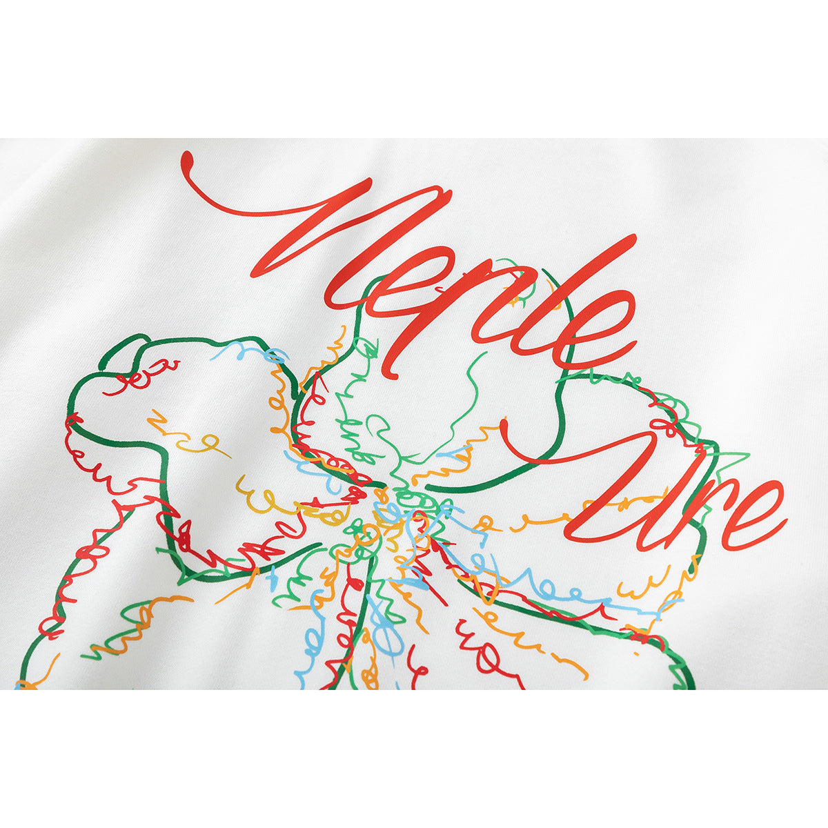 Close-up of a colorful flower line-art print with red script on white sweatshirt fabric.