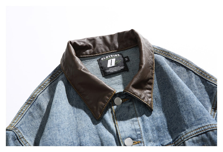 Close-up of a blue denim jacket's dark brown collar, top buttons, and sewn-in neck label.