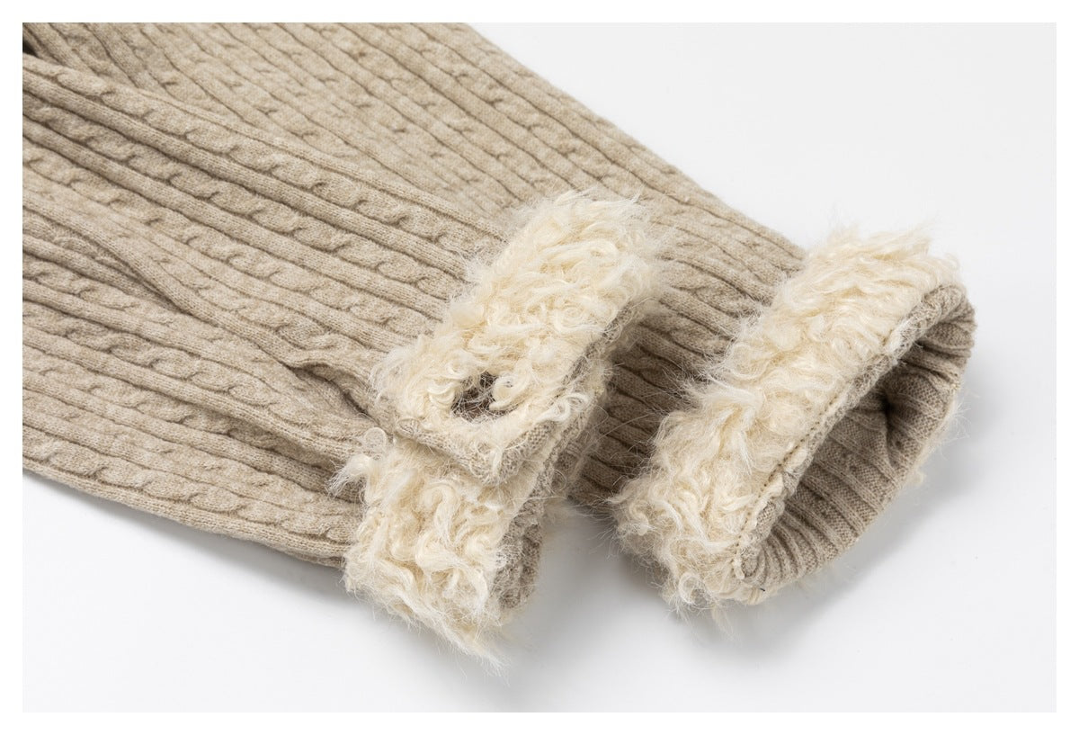 Close-up of a beige cable-knit sleeve cuff with a fluffy cream lining.
