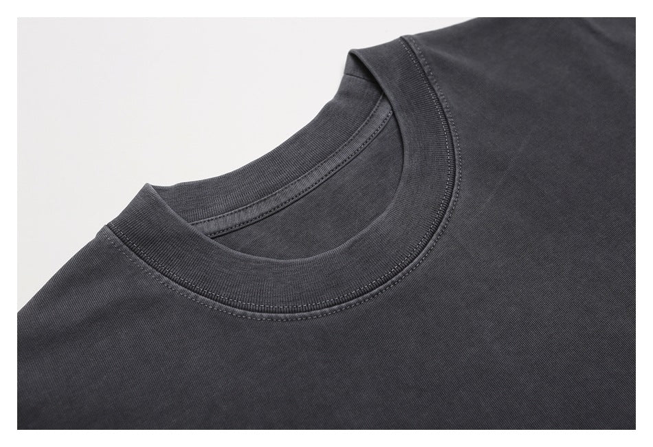 Close-up of the charcoal T-shirt's ribbed crew neck and double-stitched neckline.