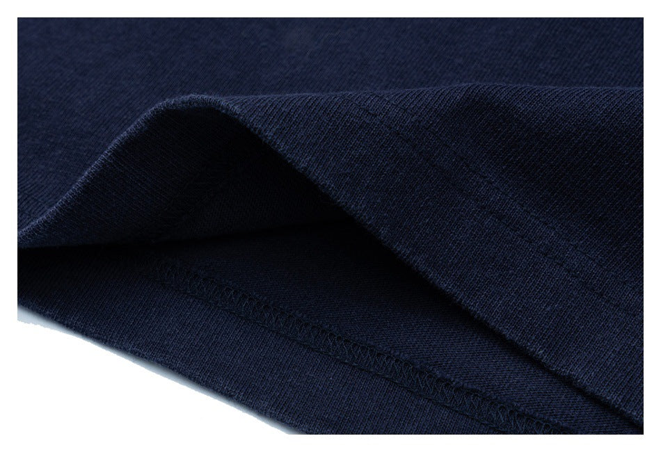 Close-up of the navy shirt's folded lower edge and stitched hem.