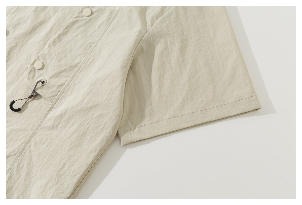 Close-up of the ivory shirt-jacket's short sleeve and stitched cuff.