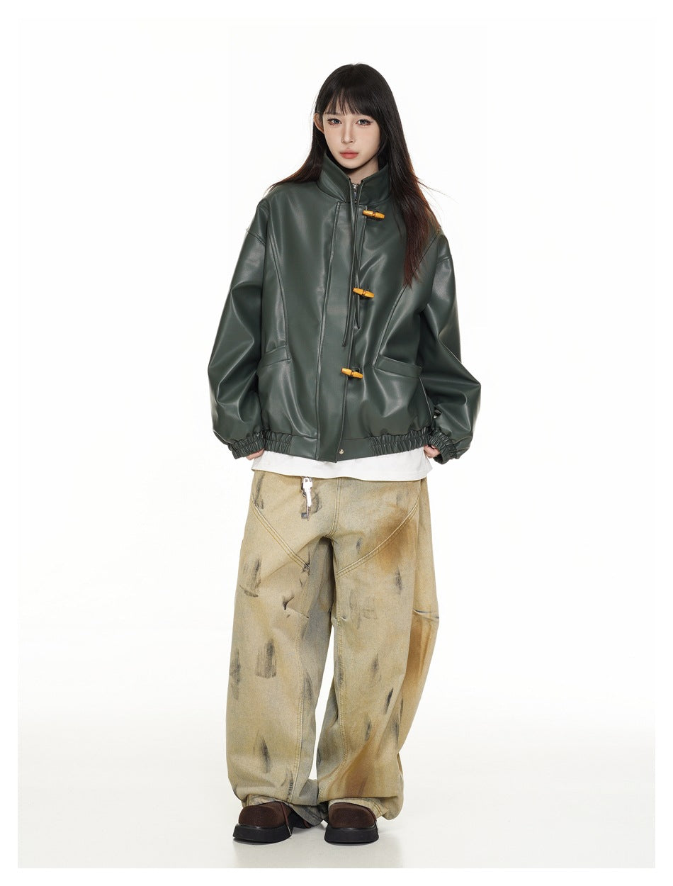 Model wearing a dark green stand-collar jacket with a front zipper, toggle closures, and gathered cuffs and hem.