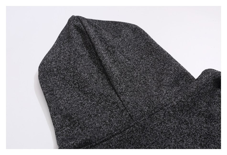 Close-up of the hood and seam on a dark heather-gray garment.