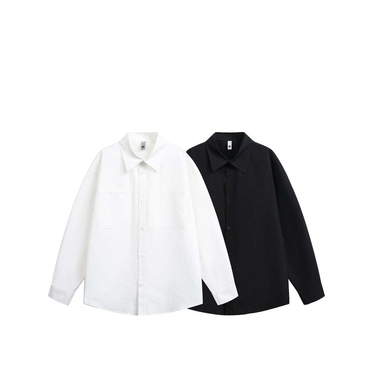 Front view of white and black long-sleeve button-up shirts, each with a pointed collar and two chest pockets.