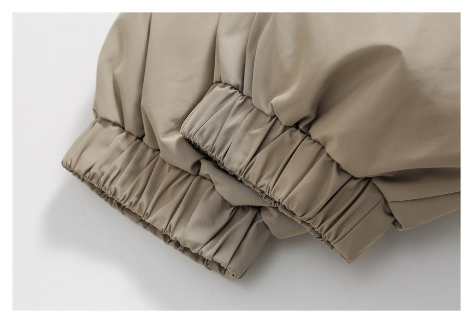 Close-up of the beige jacket's gathered elastic cuffs.