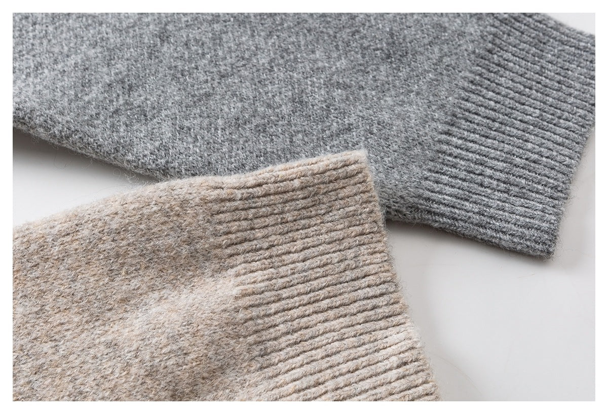 Close-up of gray and beige knitted sweater cuffs with ribbed edges.