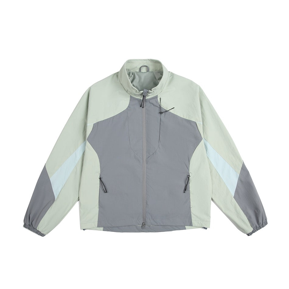 Green and gray color-block zip jacket with stand collar, light blue sleeve stripes and elastic cuffs, flat front view