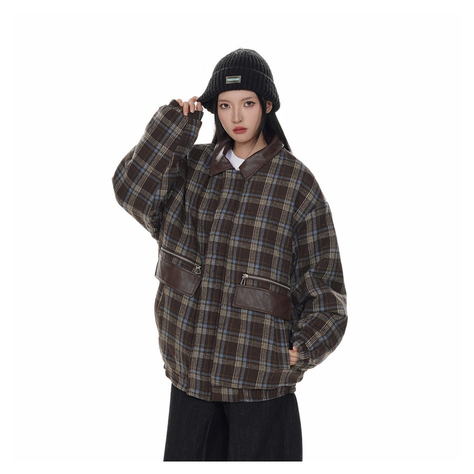 Model wearing an oversized brown plaid jacket with a dark brown collar and zip pockets, paired with a black knit beanie.