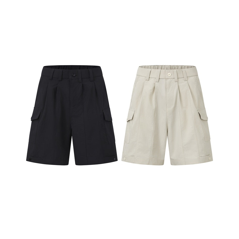 Two pairs of wide-leg cargo shorts shown side by side: black and ivory, both with pleats, side pockets and hem snaps.