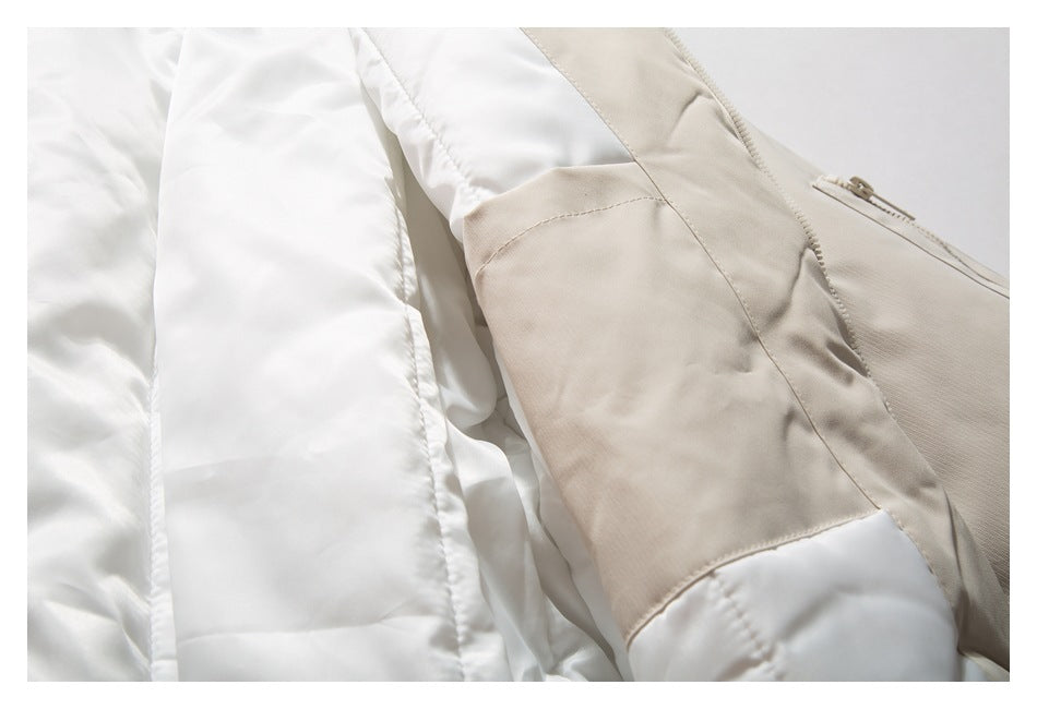 Close-up of a garment interior with white quilted lining beside beige panels and a small zipper.