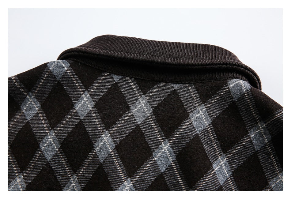 Close-up of the dark ribbed collar and gray plaid shoulder area.