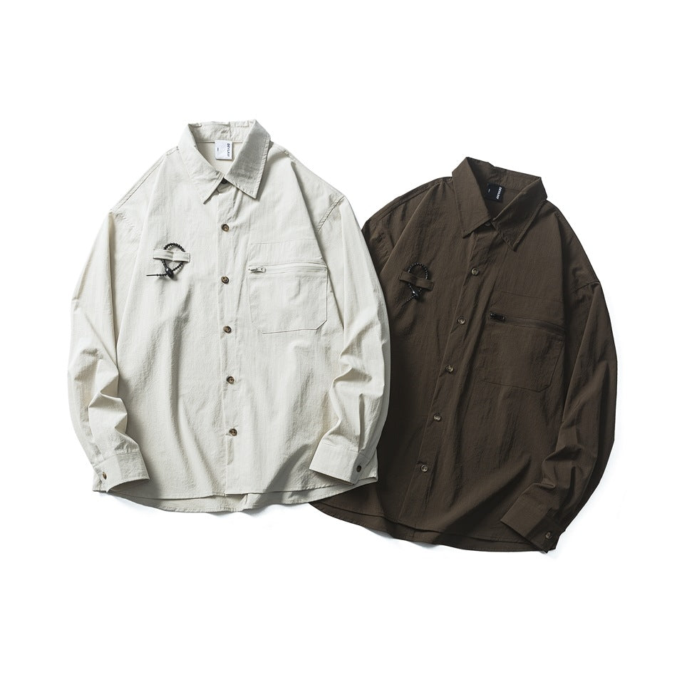 Light beige and dark brown button-front shirts displayed together, each with chest pockets and cord details.