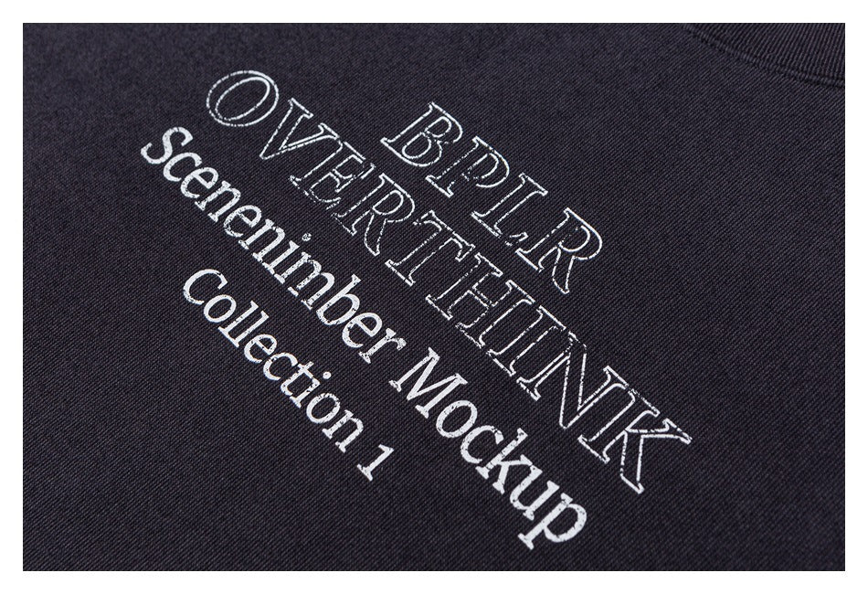 White text artwork printed diagonally across dark fabric.